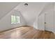 Charming bedroom with hardwood floors, vaulted ceiling, window with trim, and a white painted door at 1155 Peachtree Battle Nw Ave, Atlanta, GA 30327