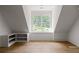 Upstairs bonus room with vaulted ceiling, light hardwood floors, and built-in shelves at 1155 Peachtree Battle Nw Ave, Atlanta, GA 30327