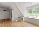 Light-filled bonus room with hardwood flooring, built in shelving, and a window seat at 1155 Peachtree Battle Nw Ave, Atlanta, GA 30327