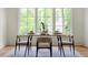 Bright dining room featuring a large window overlooking a lush, green outdoor area, and modern dining set at 1155 Peachtree Battle Nw Ave, Atlanta, GA 30327