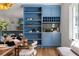 A charming dining area featuring bright blue built-ins and an adjacent kitchen at 1155 Peachtree Battle Nw Ave, Atlanta, GA 30327