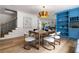 Elegant dining room with a wooden table, stylish chairs, and an eye-catching gold chandelier at 1155 Peachtree Battle Nw Ave, Atlanta, GA 30327