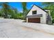 Exterior view showcasing a modern home with a spacious driveway and a two-car garage at 1155 Peachtree Battle Nw Ave, Atlanta, GA 30327