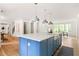 Open concept kitchen with bright island and a view into dining and living areas at 1155 Peachtree Battle Nw Ave, Atlanta, GA 30327