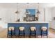Modern kitchen island featuring a white countertop and stylish stools with overhead lighting at 1155 Peachtree Battle Nw Ave, Atlanta, GA 30327