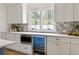 Well-lit kitchen featuring modern countertops, white cabinets, and stainless steel appliances at 1155 Peachtree Battle Nw Ave, Atlanta, GA 30327