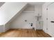 Upstairs laundry room with sink, shaker cabinets, and hardwood floors at 1155 Peachtree Battle Nw Ave, Atlanta, GA 30327