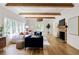 Bright living room with hardwood floors, wooden ceiling beams, and large windows at 1155 Peachtree Battle Nw Ave, Atlanta, GA 30327
