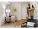 Cozy living room featuring a stone fireplace, modern artwork, and hardwood floors at 1155 Peachtree Battle Nw Ave, Atlanta, GA 30327