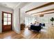 Inviting living room featuring hardwood floors, ceiling beams, and a stylish front door at 1155 Peachtree Battle Nw Ave, Atlanta, GA 30327