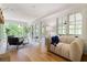 Inviting living room with modern furniture, large windows, and hardwood floors, and plenty of natural light at 1155 Peachtree Battle Nw Ave, Atlanta, GA 30327