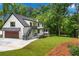 Side view of the home exterior showing a garage, patio, and screened-in porch at 1155 Peachtree Battle Nw Ave, Atlanta, GA 30327