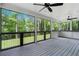 Covered screened porch with gray wood-look flooring, and open views of the green backyard at 1155 Peachtree Battle Nw Ave, Atlanta, GA 30327