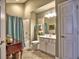 Bathroom featuring a shower-tub combo with a curtain, a white vanity, and a tiled floor, providing a functional space at 174 Vintage Club Cir, Marietta, GA 30066