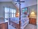 Well-lit bedroom featuring a four-poster bed, matching nightstands, and a window providing natural light at 174 Vintage Club Cir, Marietta, GA 30066