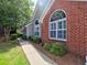 Beautiful home exterior with brick accents, arched windows, and lush greenery at 174 Vintage Club Cir, Marietta, GA 30066