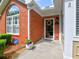Inviting front entrance with brick facade, wreath, and neatly trimmed landscaping at 174 Vintage Club Cir, Marietta, GA 30066