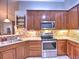 Modern kitchen with stainless steel appliances, granite countertops, and tiled backsplash at 174 Vintage Club Cir, Marietta, GA 30066
