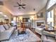 Inviting living room features a ceiling fan, a fireplace, and large windows that provide plenty of natural light at 174 Vintage Club Cir, Marietta, GA 30066
