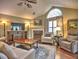 Cozy living room with vaulted ceilings, fireplace, and large windows for natural light at 174 Vintage Club Cir, Marietta, GA 30066