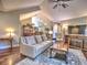 Spacious living room with hardwood floors, ceiling fan and a comfortable couch is ideal for relaxation and entertaining guests at 174 Vintage Club Cir, Marietta, GA 30066