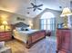Charming main bedroom features a patterned bed set, vaulted ceilings and natural light from the large window at 174 Vintage Club Cir, Marietta, GA 30066