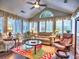 Bright sunroom with large windows, a ceiling fan, and comfortable seating creates a relaxing and inviting atmosphere at 174 Vintage Club Cir, Marietta, GA 30066