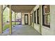 Covered back porch featuring exposed wood beams, a white brick wall, and recessed lighting at 2346 East Maddox Rd, Buford, GA 30518
