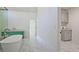 Bright bathroom features a soaking tub, marble floors, and a modern green vanity at 2346 East Maddox Rd, Buford, GA 30518