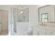 Bathroom featuring glass-enclosed shower with marble walls and white vanity at 2346 East Maddox Rd, Buford, GA 30518