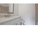 Bright bathroom featuring white vanity with quartz countertop, brushed metal faucet, and toilet at 2346 East Maddox Rd, Buford, GA 30518