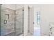 A luxurious bathroom features a glass-enclosed shower with gray marble tile and a convenient built-in shelving unit at 2346 East Maddox Rd, Buford, GA 30518