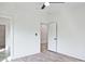 Neutral bedroom with ceiling fan and hardwood floors leads to adjacent bathroom and walk-in closet at 2346 East Maddox Rd, Buford, GA 30518