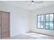 Bright bedroom features neutral walls and trim, hardwood floors, ceiling fan, and large windows with black frames at 2346 East Maddox Rd, Buford, GA 30518