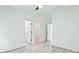 Neutral bedroom with hardwood flooring leads to adjacent bathroom and walk-in closet at 2346 East Maddox Rd, Buford, GA 30518