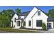 Beautiful two-story home with black framed windows and professionally landscaped yard at 2346 East Maddox Rd, Buford, GA 30518