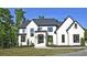 Stunning two-story home with modern black trim and a well-manicured lawn at 2346 East Maddox Rd, Buford, GA 30518