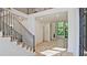 Inviting foyer with modern staircase, hardwood floors, and lots of natural light at 2346 East Maddox Rd, Buford, GA 30518