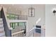 Foyer with open staircase overlooks the living room with high ceilings and modern lighting at 2346 East Maddox Rd, Buford, GA 30518