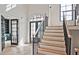 Bright entryway with staircase, hardwood floors, and views into other rooms at 2346 East Maddox Rd, Buford, GA 30518