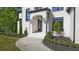 Charming front entryway with stylish black trim and manicured landscaping at 2346 East Maddox Rd, Buford, GA 30518