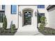 Close-up of the front entrance with elegant black framed windows and modern lighting at 2346 East Maddox Rd, Buford, GA 30518