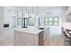 Modern kitchen with a large quartz island, stainless steel appliances, and view to the large windows at 2346 East Maddox Rd, Buford, GA 30518