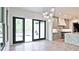 Modern kitchen features stainless appliances, marble countertops, pendant lighting and a sliding door to the patio at 2346 East Maddox Rd, Buford, GA 30518