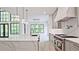 Bright kitchen with light gray cabinetry, quartz countertops, modern fixtures and chef-grade stainless steel appliances at 2346 East Maddox Rd, Buford, GA 30518