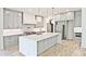 Spacious kitchen featuring a quartz island, custom cabinets, stainless steel appliances, and a gas range at 2346 East Maddox Rd, Buford, GA 30518