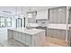 Well-equipped kitchen with stainless steel appliances, light gray cabinets, and quartz countertops at 2346 East Maddox Rd, Buford, GA 30518