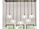 Close-up of modern, multi-bulb pendant lighting over kitchen island with black trim windows in background at 2346 East Maddox Rd, Buford, GA 30518
