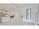 Bright, open-concept living room boasts light wood floors, fireplace, marble countertops, and modern light fixtures at 2346 East Maddox Rd, Buford, GA 30518