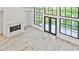 Living room with soaring ceilings and a fireplace features black trim windows and natural light at 2346 East Maddox Rd, Buford, GA 30518